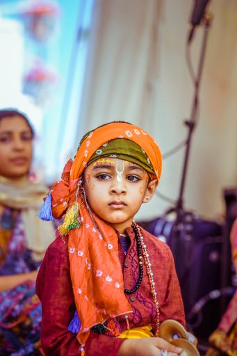 A child dressed up for a festival play performance