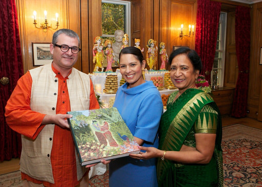 Mahaprabhu dasa giving a copy of the Ramayana to Priti Patel during Diwali Reception at 10 Downing St.